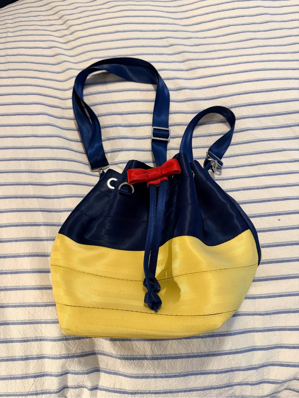 Disney x Harvey’s Seatbelt Navy, Yellow & Red Drawstring Shoulder Bucket Bag